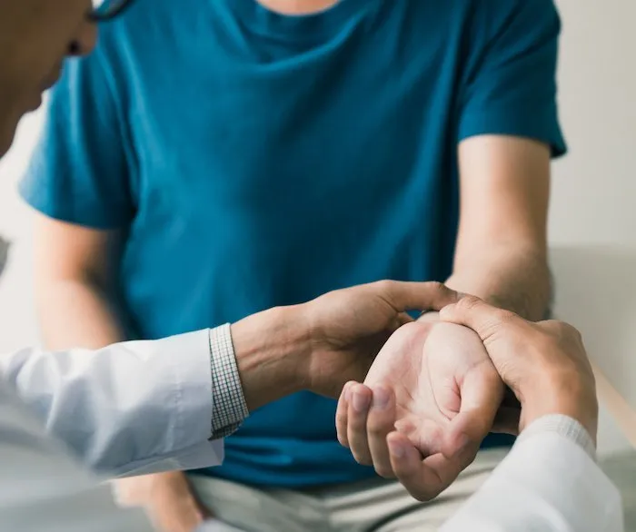 Male getting a check up on his arm for a possible fracture