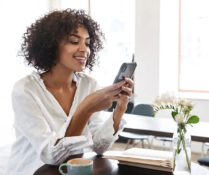 Woman using her phone during a telehealth conference with her doctor