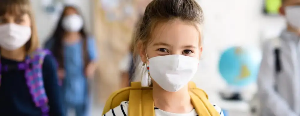 Picture of a child at school with her mask