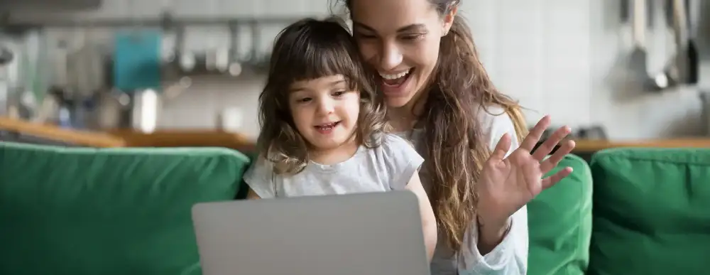 Mom and daughter doing telehealth on a computer
