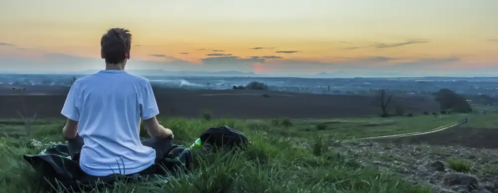 Man on a hike, looking out at the view