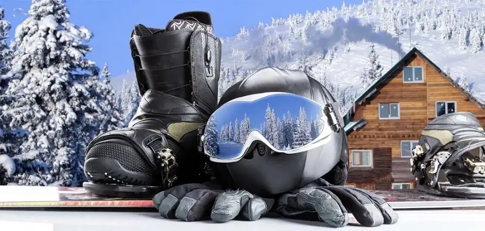 Image of a ski resort with snowboard, boots, helmet, and gloves