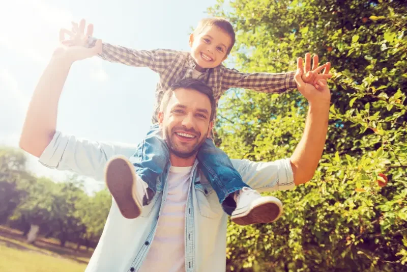 Dad, with child on his shoulders