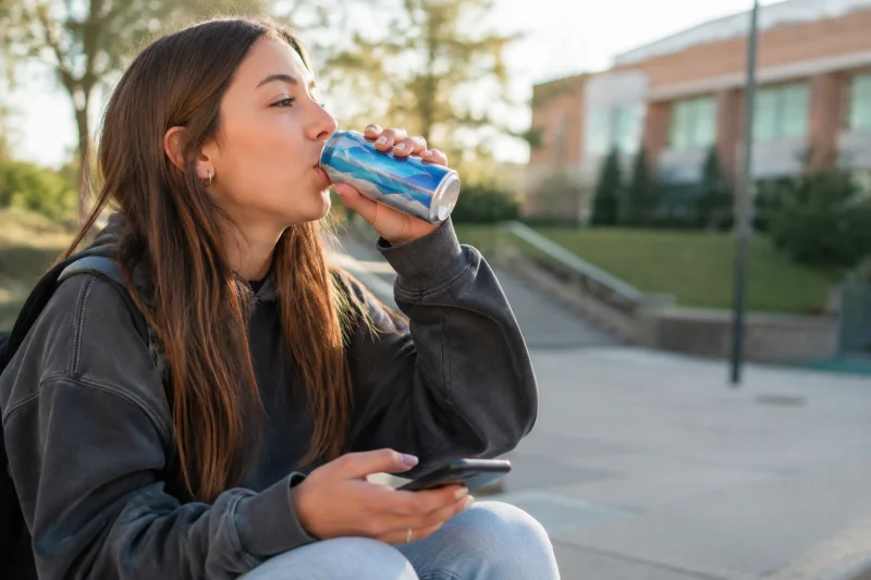 Teenage girl drinking an energy drink