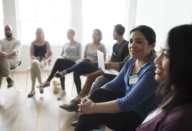 A small group of people in chairs