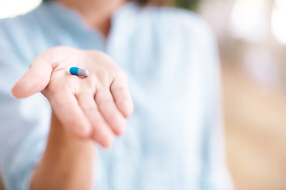 nurse holding a pill