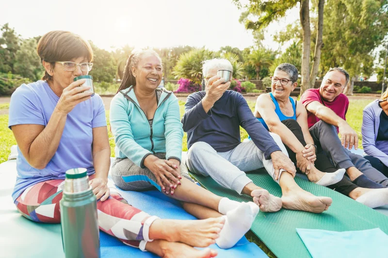 group of healthy seniors sitting on yoga mats