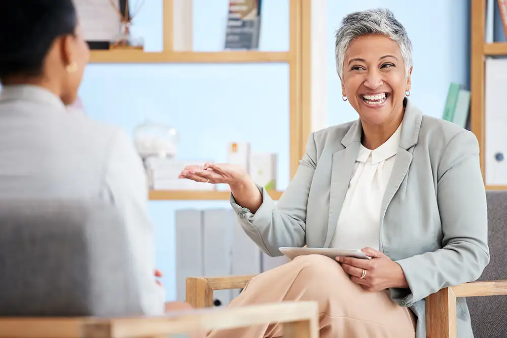 A therapist laughing with her client